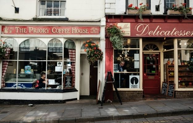 2 coffee shops with christmas decoration and the standee on the sidewalk | Google Advertising Credits for Small and Medium-Sized Businesses