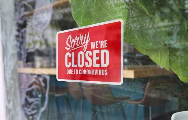 a red closed sign in front of a restaurant | Restaurant Operations During Covid19: An Update | How Food Businesses Stay Up To Date During Covid-19