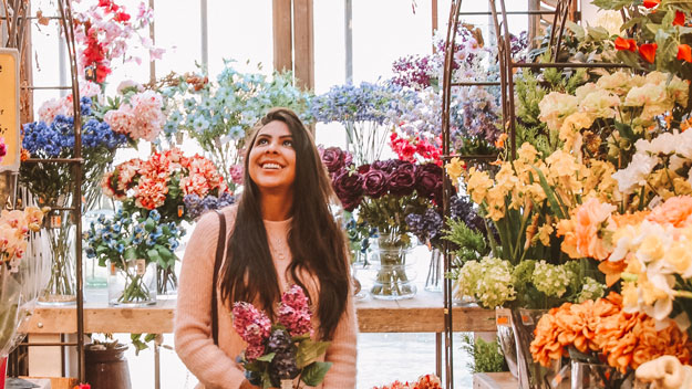 smiling_woman_in_flower_shop-sc | 5 Things Every Local Business Should Do To Boost Their Location Based Marketing | How Does Location-Based Marketing Work?