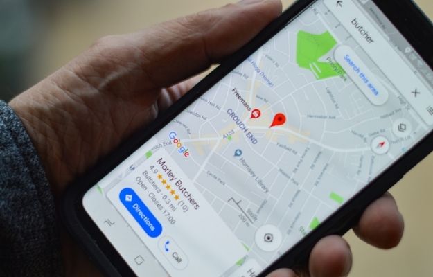 Guy holding his phone with google map open - More Than Just a Local Listing | How to Add a Black-Owned Business Attribute to Your Google Maps