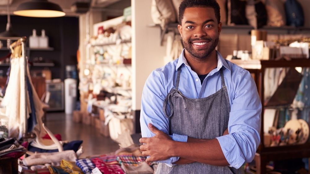 a black owner standing in front of his clothing store | Featured | How to Add a Black Owned Business Attribute to Your Google Maps