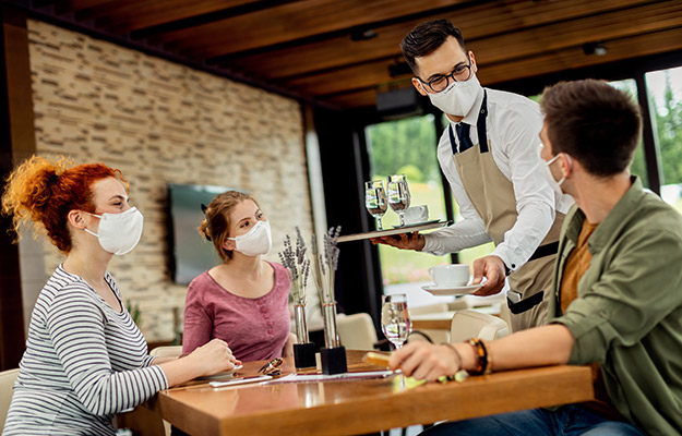 Group of people wearing mask in a coffee shop | How To Get More Foot Traffic To Your Business